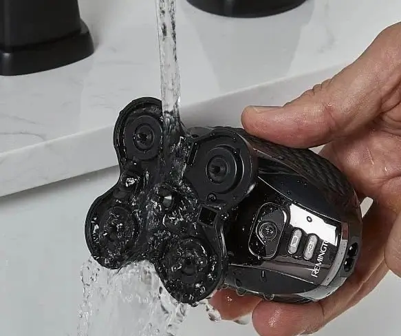 Handheld view of Remington XR7000 Balder Pro showing ergonomic palm grip design.